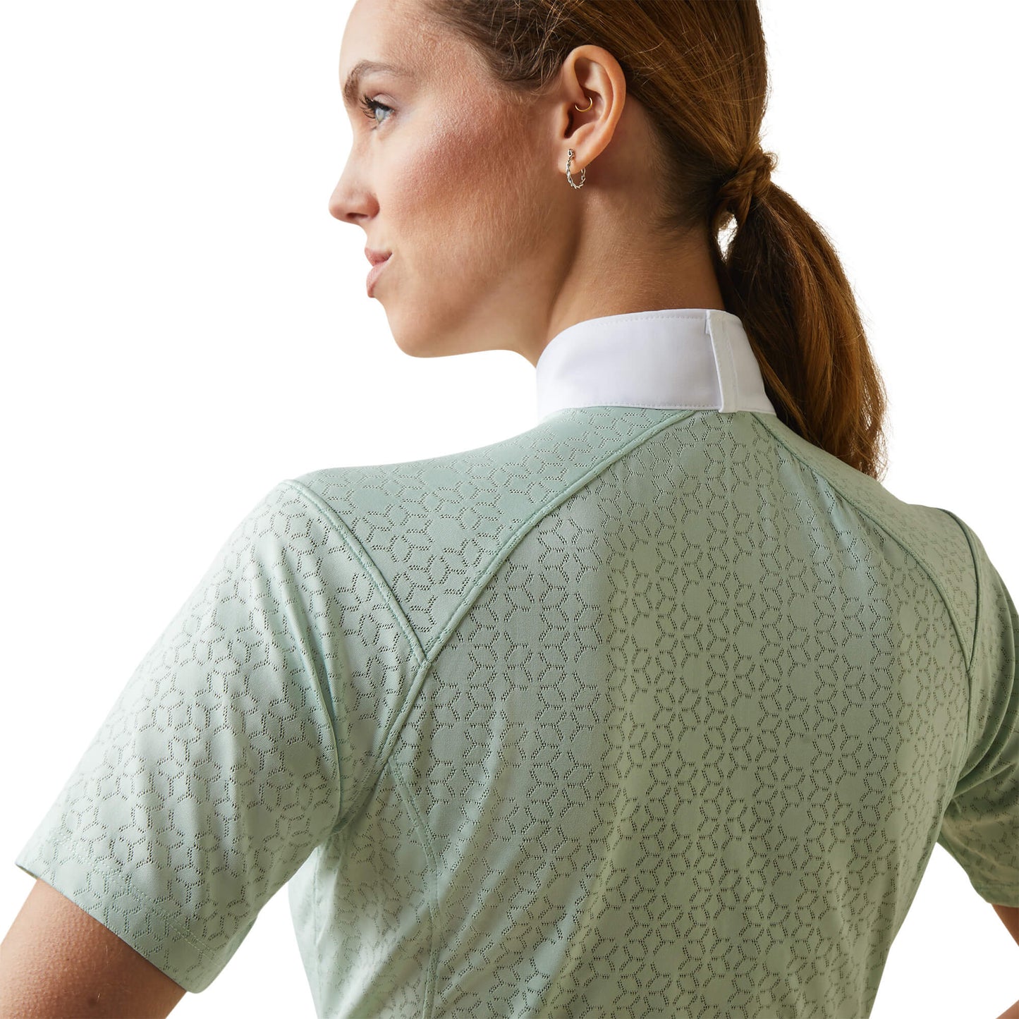 a closeup back view of a woman wearing an ariat equestrian showshirt in light green with a white collar